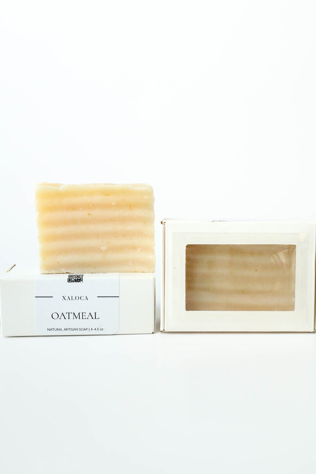 Bar of oatmeal soap in a white box on a white background