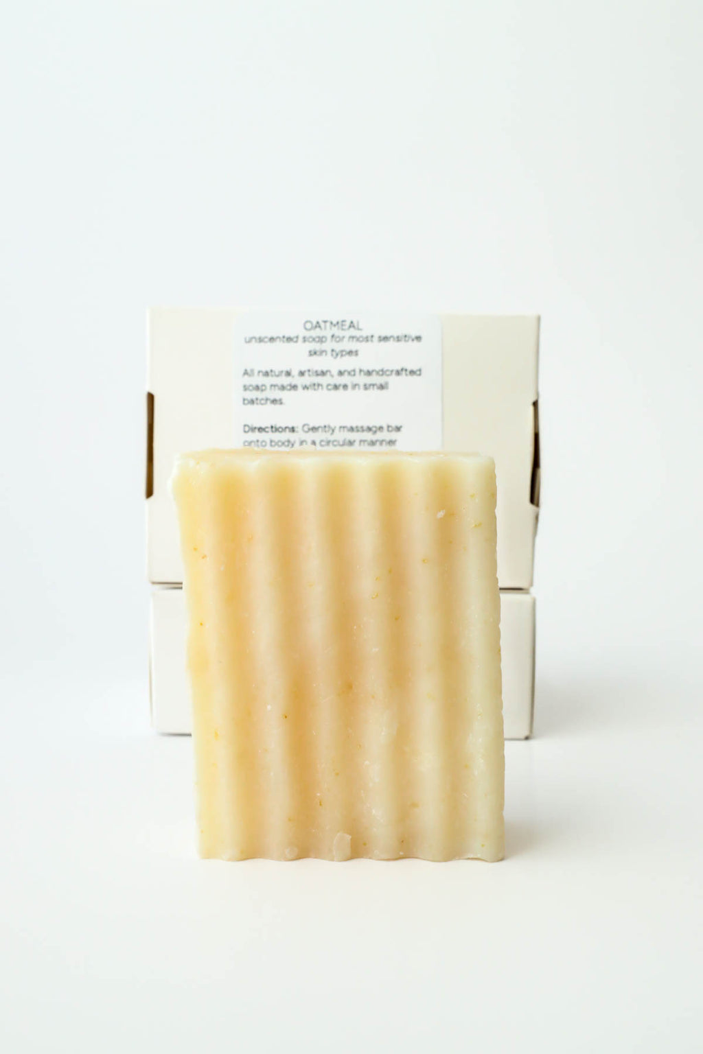 Bar of soap with a white box on a light background