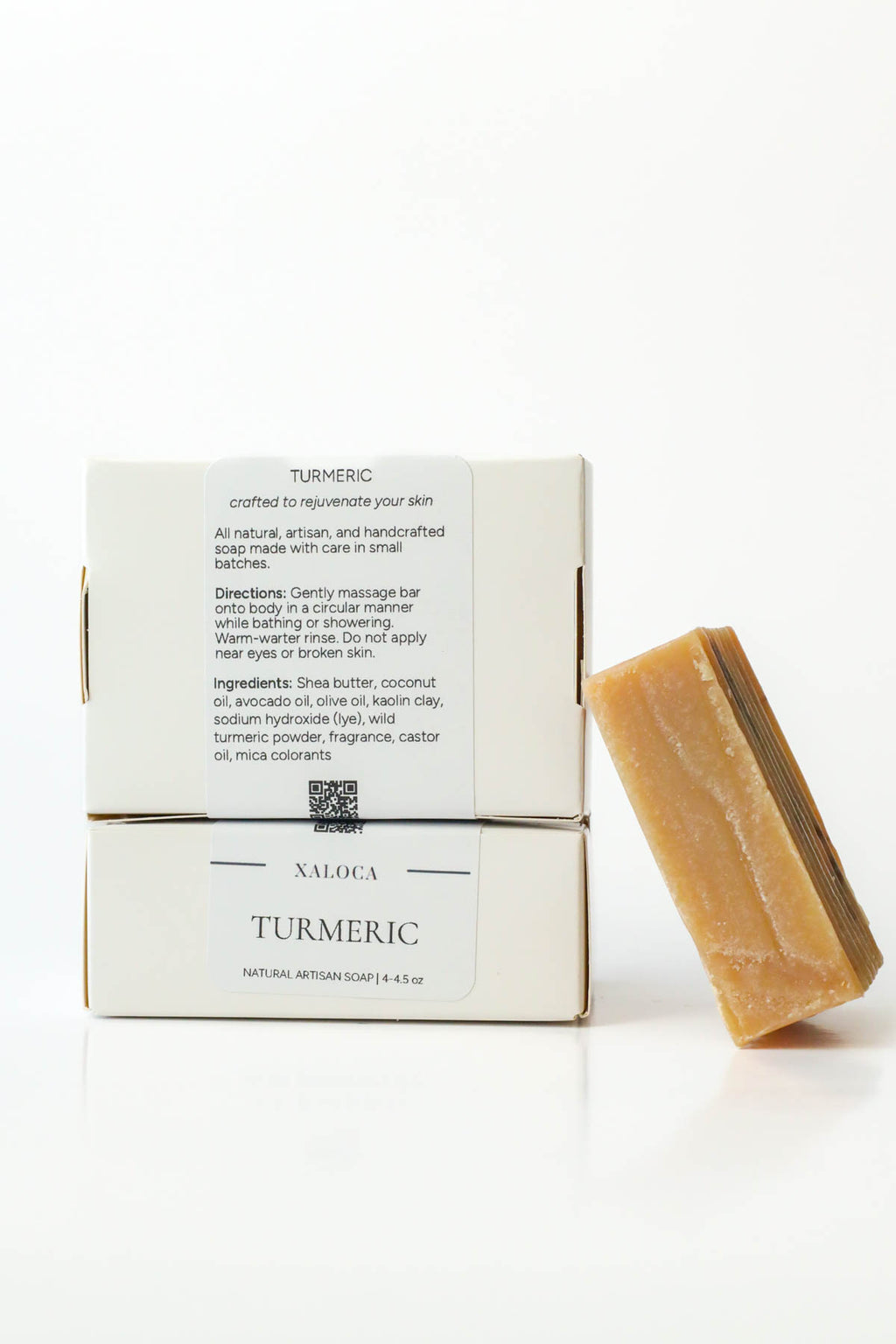 Natural soap bar with its packaging on a white background