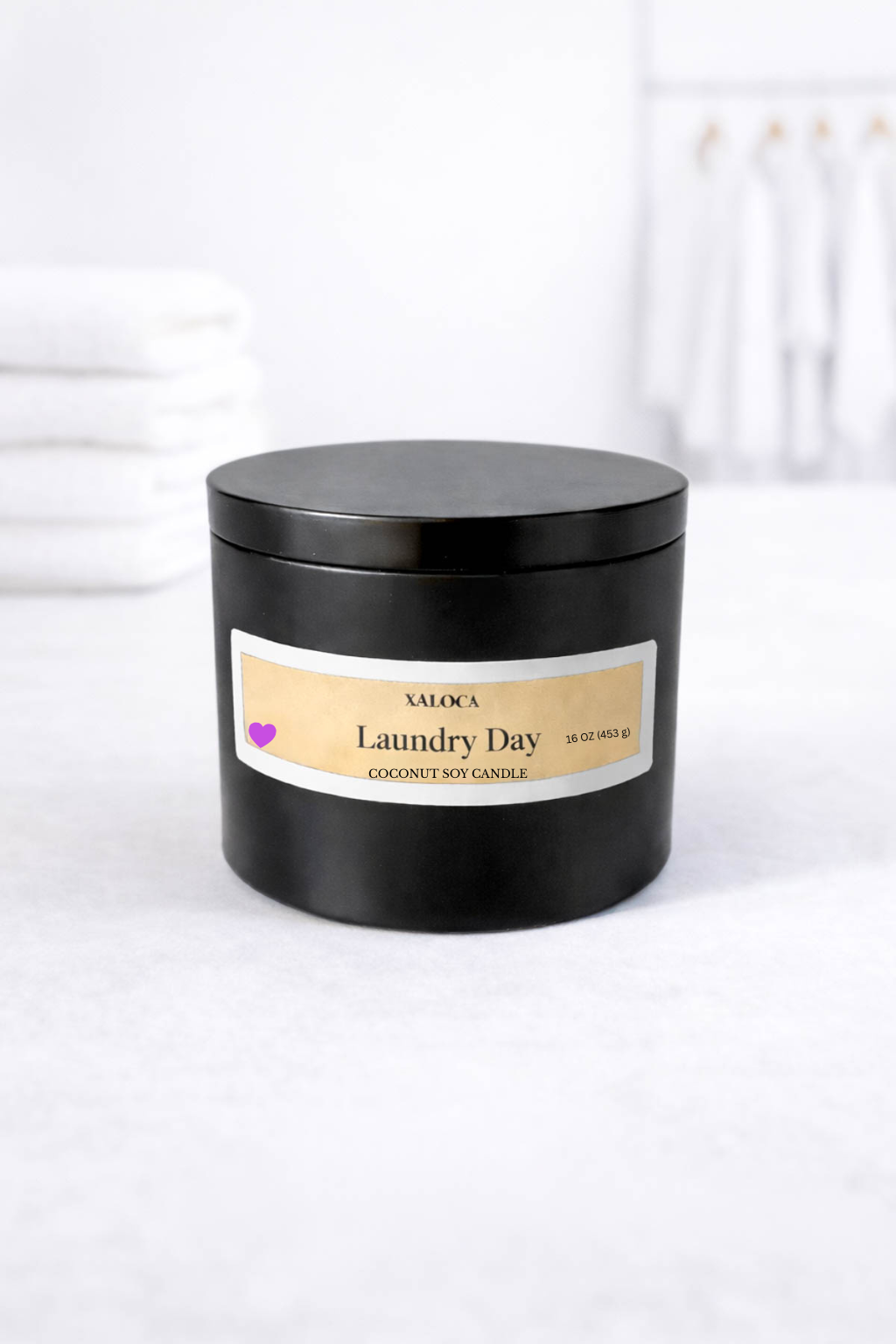 Black candle jar labeled 'Laundry Day' on a white background