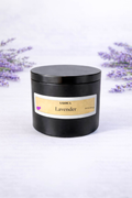 Black candle jar with a lavender label on a white background with lavender flowers.