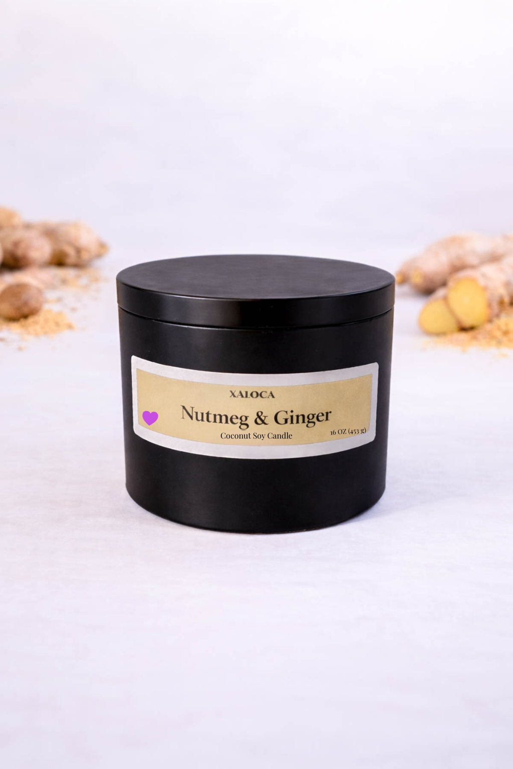 Black candle jar with 'Nutmeg & Ginger' label on a white background