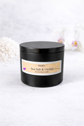 Black candle jar with 'Sea Salt & Orchid' label on a white background