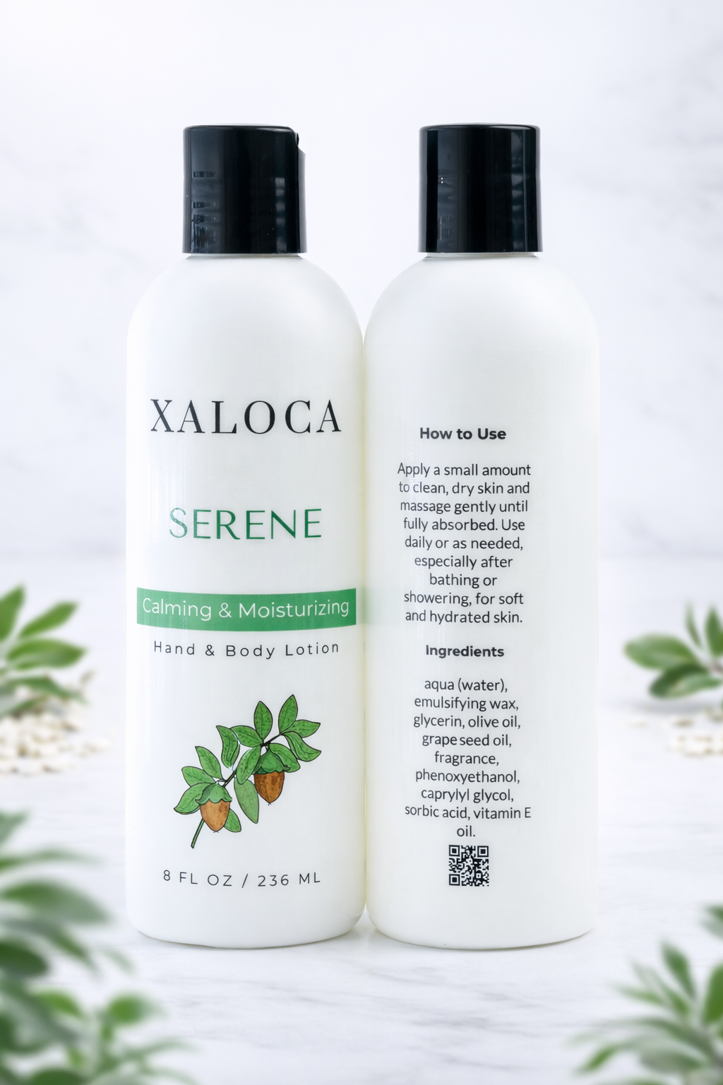 Two bottles of Xaloca Serene Calming & Moisturizing Hand & Body Lotion on a white background with greenery.